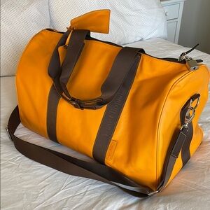 Veuve Clicquot Orange Leather Weekend Travel Bag with Brown Suede Lining